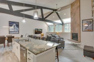 an open kitchen and living room with a fireplace at Modern Townhome about 4 Miles to Beaver Creek Resort! in Avon