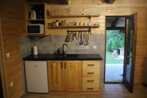 a kitchen with a sink and a counter top at Holiday home The Hive in Slunj