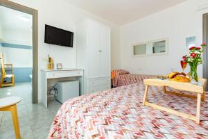 a living room with a bed and a tv at Il Magnolia in Francavilla al Mare