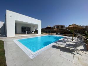 a swimming pool in front of a villa at Villa Lorisa in Tanaunella