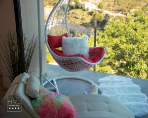 een kamer met een schommel, een bed en een raam bij Hotel Spa Mirador in Jorquera