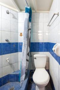 a bathroom with a white toilet and a shower at Casa Jessica 326 Heavens Place One bedroom plus loft Condo Unit in Bacoor