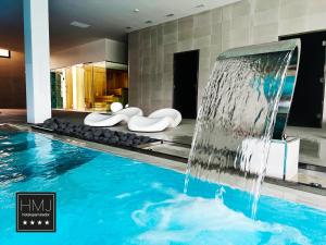 a swimming pool with a waterfall in a hotel room at Hotel Spa Mirador in Jorquera
