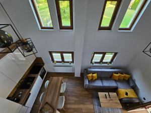 an attic living room with a couch and a table at Apartman Marin in Livno