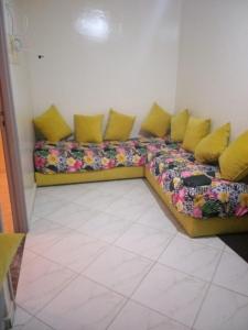 divano con cuscini gialli in camera di جنان أزمور بمدينة أزمور a Azemmour