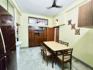 eine Küche und ein Esszimmer mit einem Tisch und Stühlen in der Unterkunft Spacious 3BHK House opp South City Mall in Kalkutta