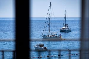two boats floating in the water in the ocean at Hotel California by Aycon in Sveti Stefan