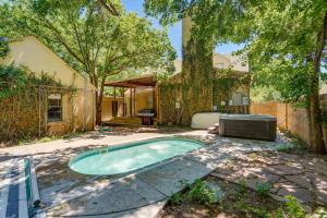 a swimming pool in the yard of a house at Amarillo Vacation Rental with Shared Pool! in Amarillo