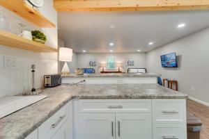 a kitchen with white cabinets and a counter top at Amarillo Vacation Rental with Shared Pool! in Amarillo