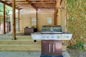 a barbecue grill on a deck with a building at Amarillo Vacation Rental with Shared Pool! in Amarillo