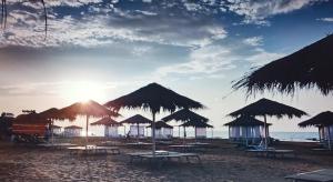 a group of tables and umbrellas on a beach at Sea Breeze in Baku