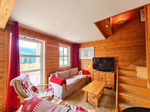 a living room with a couch and a tv at Chalet Flaine, 4 pièces, 8 personnes - FR-1-425-198 in Arâches-la-Frasse