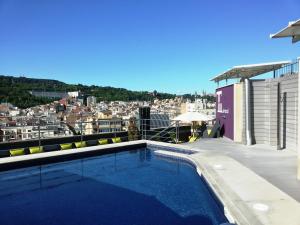a swimming pool on the roof of a building at Hotel Barcelona Universal in Barcelona