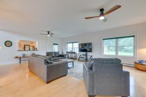 a living room with two couches and a ceiling fan at Secluded Calais Getaway Deck, Hot Tub and More! 