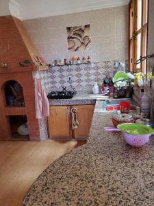 a kitchen with a counter and a counter top with a counter top at Apartement en 1er etage et autre 2eme avec terasse location longue duré in Essaouira