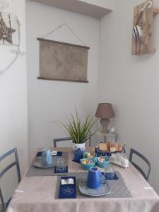 a dining room table with blue dishes on it at Villa Bella Sera in Scilla