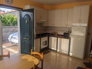 a kitchen with a refrigerator and a table and a table sidx sidx at Alicia Bis in Sanxenxo