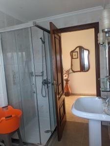 a bathroom with a shower and a tub and a sink at Alicia Bis in Sanxenxo