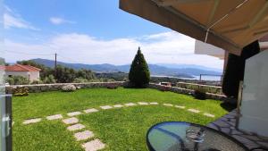 a view of a garden with a table in a yard at Villa Gianna in Apolpaina +7 photos