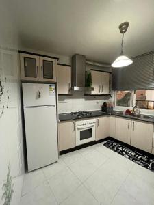 a kitchen with a white refrigerator and a stove at Mccoy avenida 3 in Macael