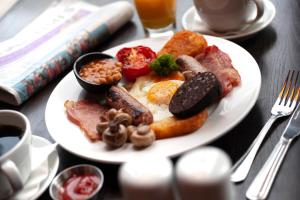 a plate of breakfast food on a table at Sandman Signature Newcastle Hotel in Newcastle upon Tyne