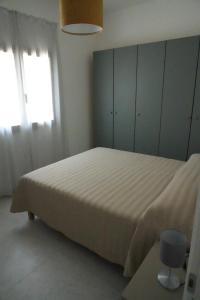 Ένα ή περισσότερα κρεβάτια σε δωμάτιο στο Appartamento AL FARO +5 φωτογραφίες
