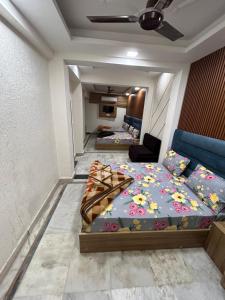 a bedroom with two beds and a couch at HOTEL DIVYA in Rishīkesh
