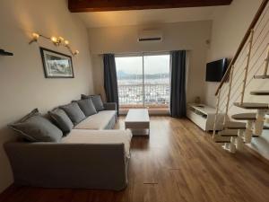 sala de estar con sofá y ventana grande en Appartement face à la mer, en Le Pradet