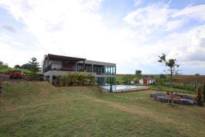 a house on top of a hill with a yard at Million Stars Poolvilla in Wang Nam Khieo