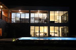 a house at night with a swimming pool in front of it at Million Stars Poolvilla in Wang Nam Khieo
