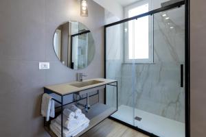 a bathroom with a sink and a shower at Le Gemme di Cavour Luxury Rooms in Palermo