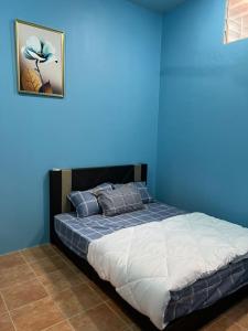 Postel nebo postele na pokoji v ubytování Norul Homestay