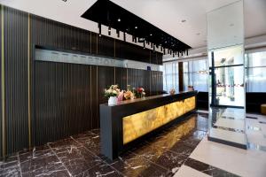 a lobby of a hotel with a reception desk at Riviera Blue Hotel in Sunny Beach +61 photos