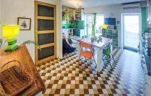 a kitchen with a table and a checkered floor at Nice Apartment In Saint-tienne With Kitchen in Saint-Étienne