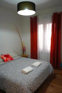 a bedroom with a bed with two towels on it at Casa Galdós in Logroño