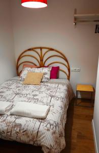 a bedroom with a large bed with a wooden headboard at Casa Galdós in Logroño