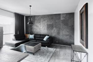 a living room with a couch and a table at Domaniewska Qbik Lofts in Warsaw