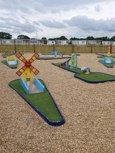 a playground with many different types of play equipment at Sands Holiday Chalet in Scratby