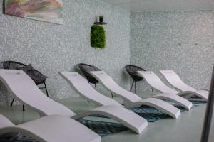 a row of chairs in a room with a table at Hôtel et SPA du Château in Lagord