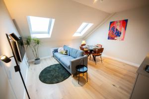 un soggiorno con divano blu e tavolo di Adorned 3 Bedroom Apartment a Rotterdam