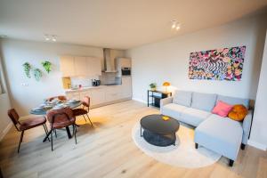 a living room with a couch and a table at Ample 3 Bedroom Apartment in Rotterdam