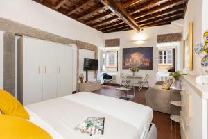 a bedroom with a bed and a living room at Amazing Via del Babuino - Piazza del Popolo in Rome