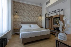 a bedroom with a bed and a television in it at Le Gemme di Cavour Luxury Rooms in Palermo