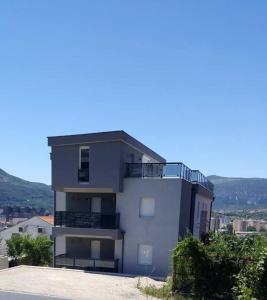 a white building with a balcony on top of it at Villa Scandinavia in Mostar