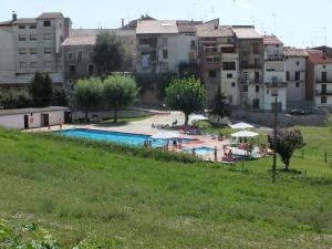 a view of a swimming pool with buildings in the background at La Llar de Peramola in Peramola