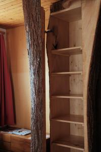 a closet with wooden shelves in a room at Hotel Tourist in Meiringen