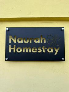 a sign for a naughan hangerery on a wall at Naurah Homestay Kulai Mslim Only in Kulai
