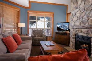 a living room with a couch and a fireplace at Legends in Whistler