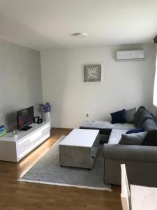 a living room with a couch and a coffee table at Apartman/Stan na dan Teslić in Teslić