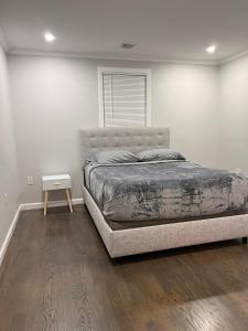 a bedroom with a bed and a wooden floor at Single family Home ONLY long term booking of 28 days or longer in Boston